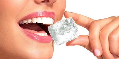 Woman biting on an ice cube