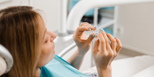 Closeup of patient holding clear aligner