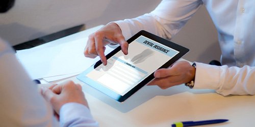 Patient looking at dental insurance form on tablet