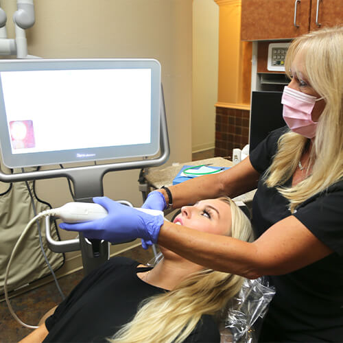 Dental team member using digital bite impression system