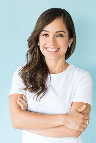 Young woman smiling with her arms crossed