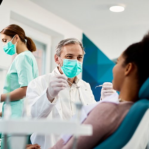 Dentist smiling at his patient