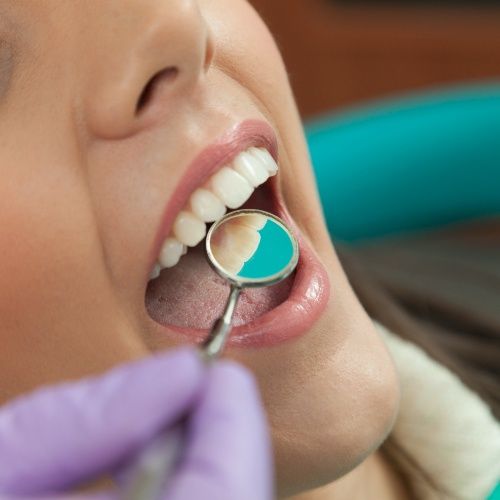 Dentist examining patient's metal free dental restorations