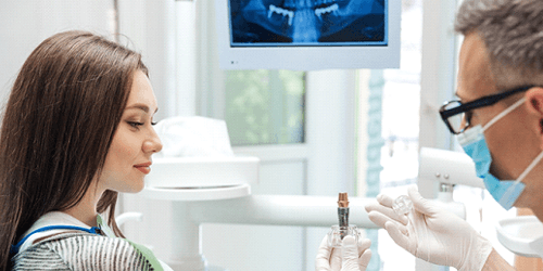 A dentist explaining the cost of dental implants in Flower Mound