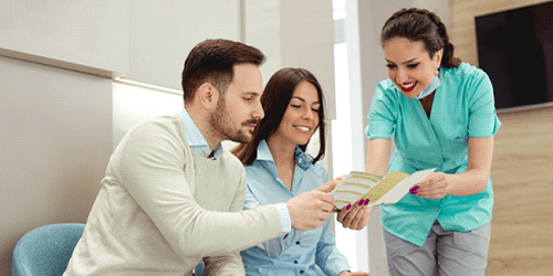 Patients consulting on how to lower the cost of dental implants in Flower Mound