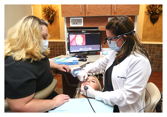 Dentist and team member treating dental patient in Flower Mound