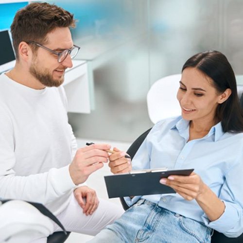 Patient and dental team member conversing