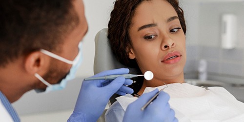 Woman afraid in the dental chair