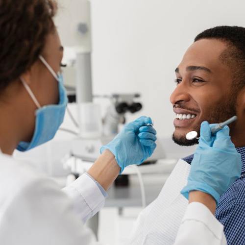 a patient smiling during an oral cancer screening