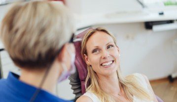 Woman smiling during preventive dentistry visit