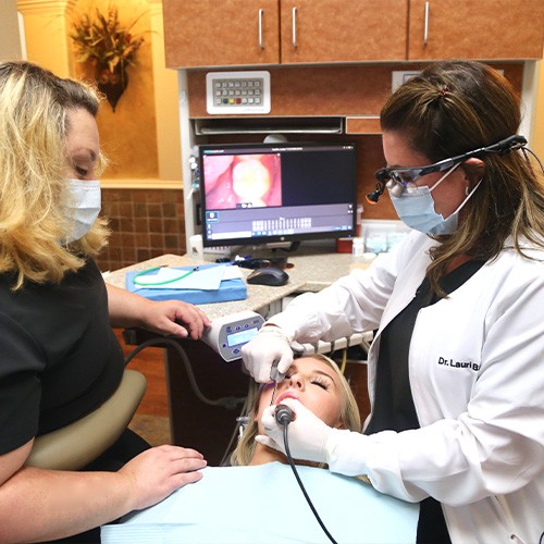 Dentist and team member using intraoral camera to capture smile images