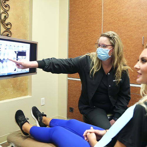 Dentist and patient looking at digital x-rays