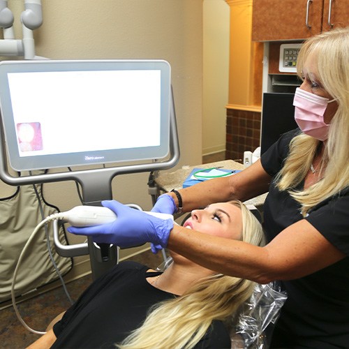 Dentist and patient looking at images from digital impression system