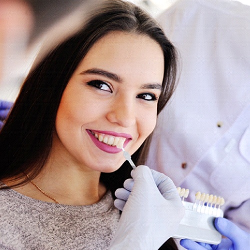Woman smiling during consultation with cosmetic dentist in Flower Mound