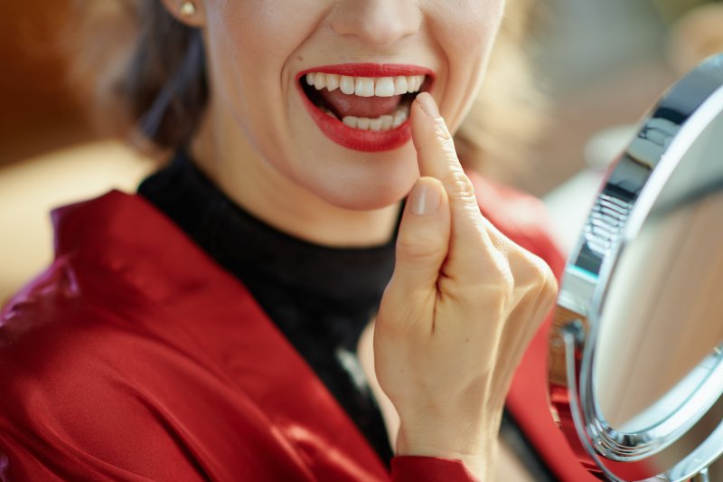 Woman pointing to dental crown