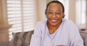 Closeup of smiling patient with implant dentures in Flower Mound