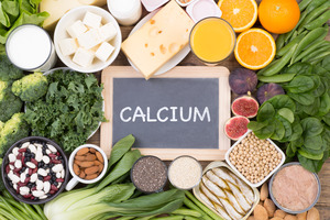Chalkboard reading “Calcium” surrounded by foods high in calcium