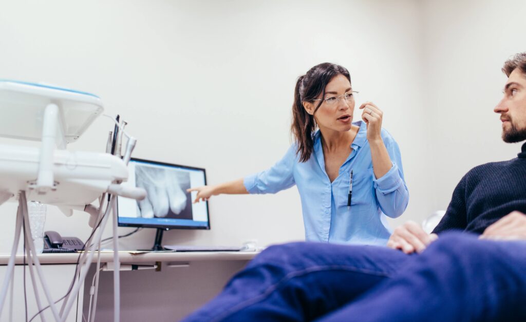 Dentist explaining X-ray to patient