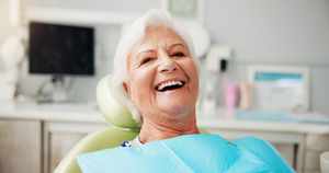 Senior woman in dental chair laughing